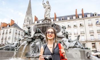 Une jeune femme joue les touristes dans la ville de Nantes